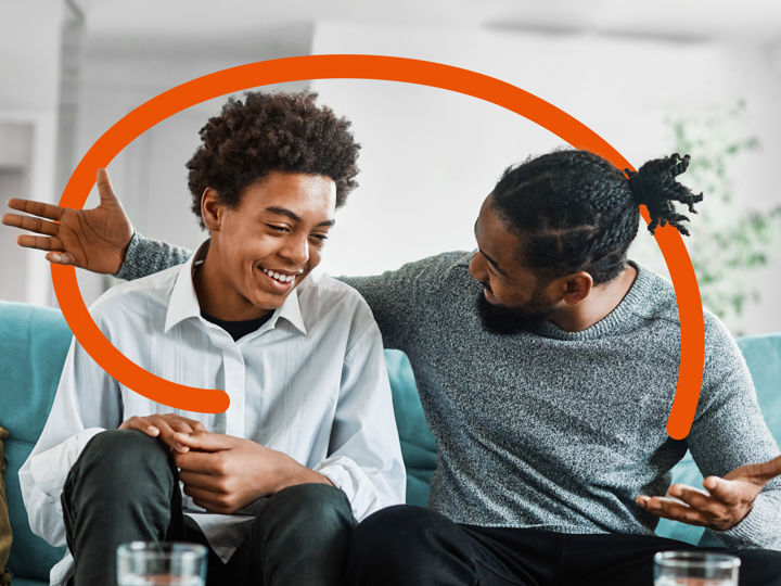 Man and teenager sitting on sofa - with Clinical Partners brand expression.jpg